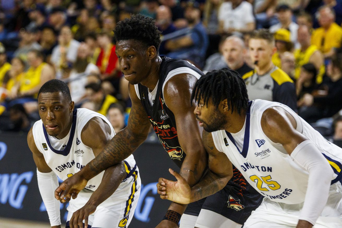 Edmonton’s Devonte Bandoo (10) and Keon Ambrose-Hylton (25)...